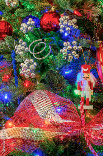 Decorated Christmas Tree in red , white and blue with wooden soldier close up.