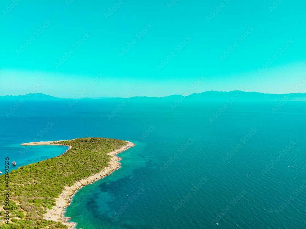 Aerial drone shot of beautiful Maldives island and horizon with mountains. Summer landscape with blue sky and clean sea.