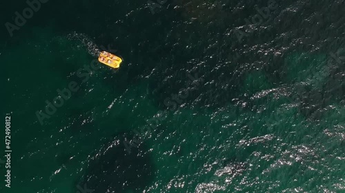 Happy family on a yellow catamaran in the open sea, view from a height