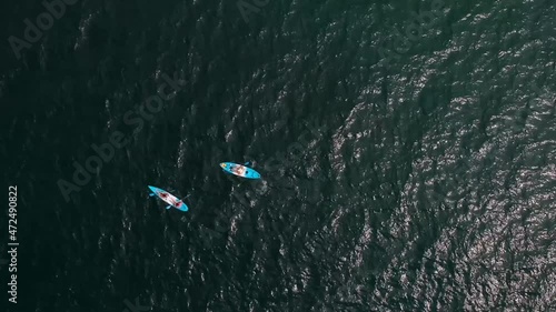People on a blue kayak in the open sea, a view from a height