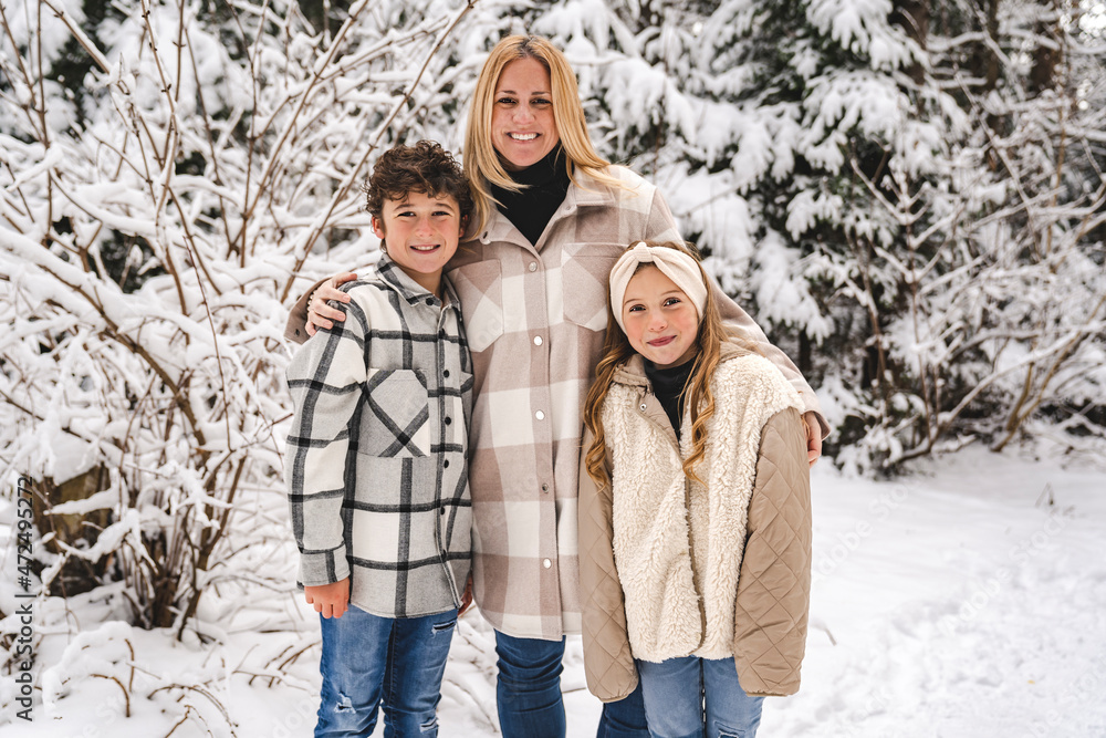 mother and children on forest in winter season mother and children on forest in winter season