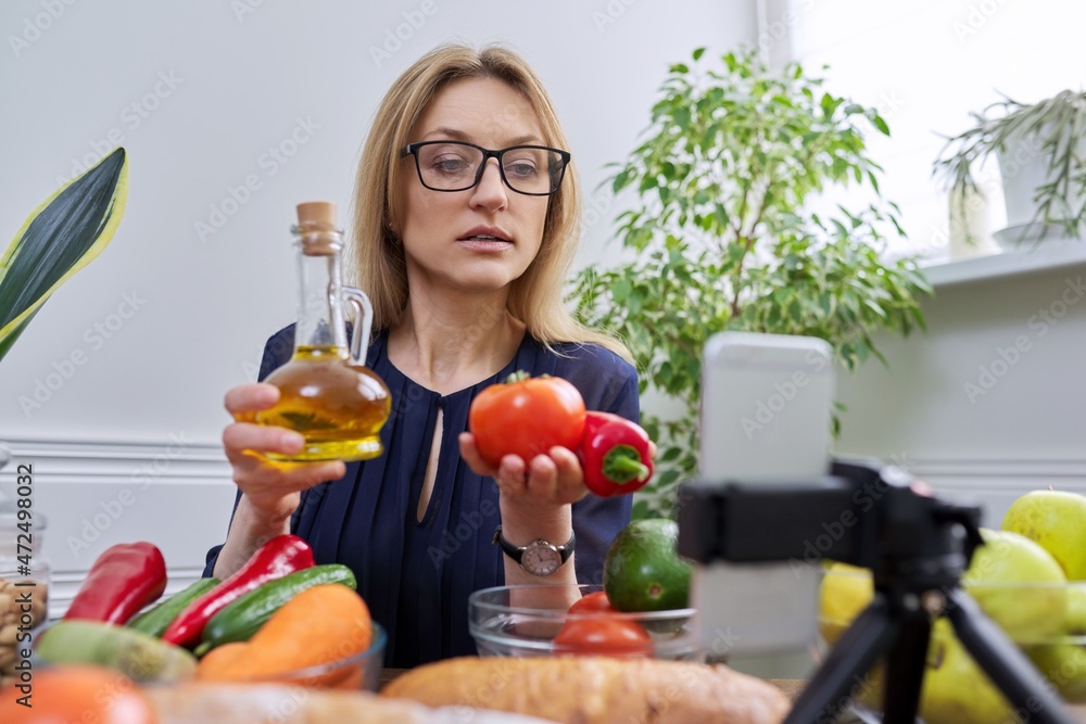 Woman nutritionist recording a video about healthy food, nutrition Woman nutritionist recording a video about healthy food, nutrition