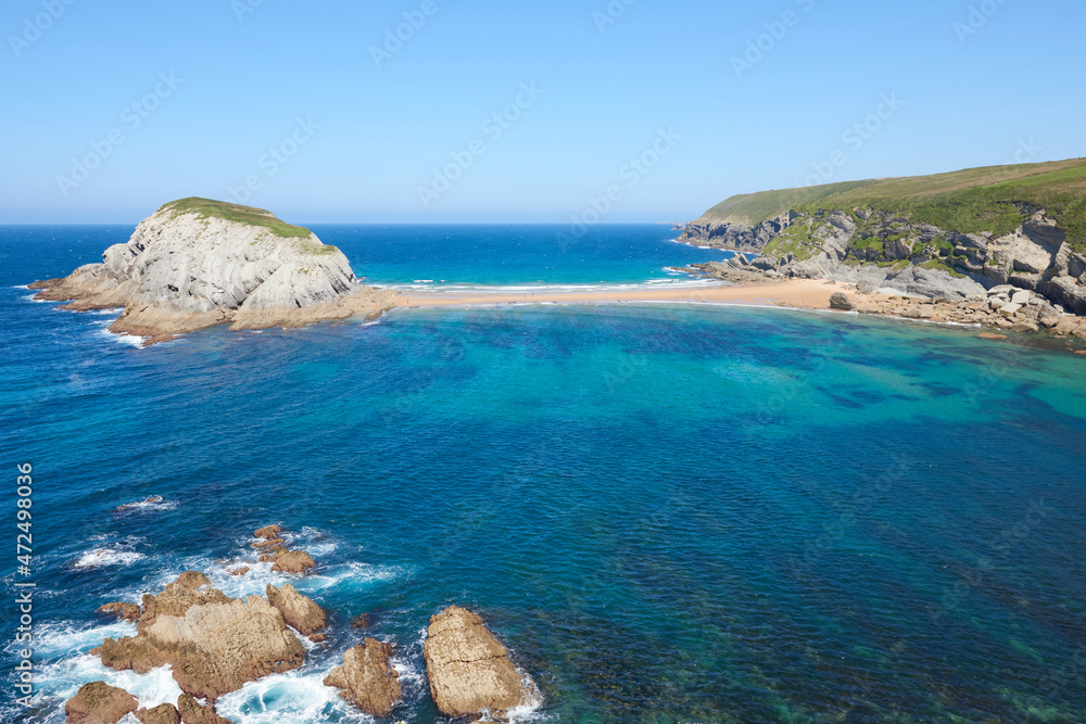Cliffs surrounded by clear waters and blue skies