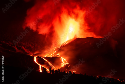 Cumbre Vieja volcano at La Palma erupting at night. Lava streams glows in the dark.