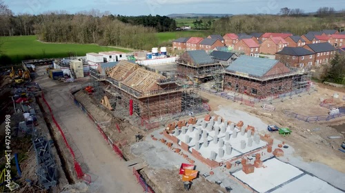 New UK housing development, showing houses under construction and new builds, in the UK. 4K Arial footage, high quality videography. UK housing project, all stages of construction and development. 