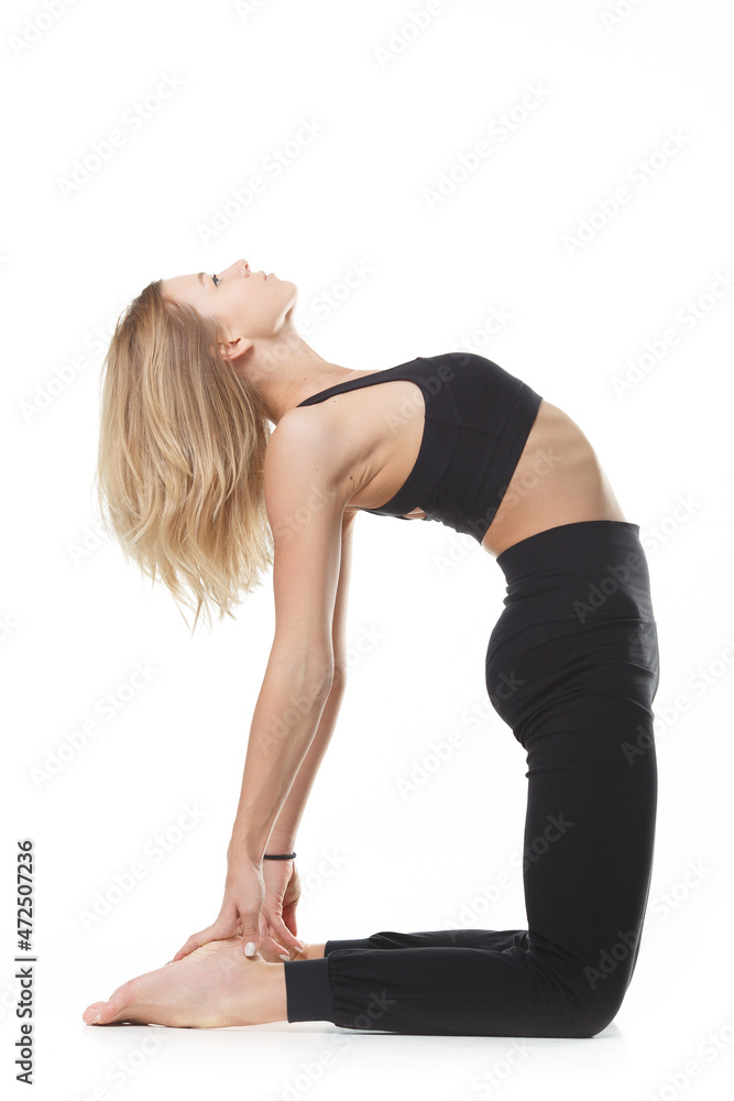 Isolated portrait of a girl at a yoga class. White caucasian girl doing yoga on a white background.