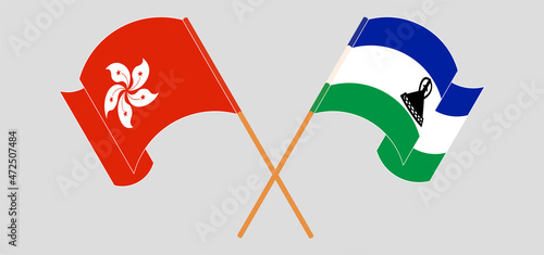Crossed and waving flags of Hong Kong and Kingdom of Lesotho