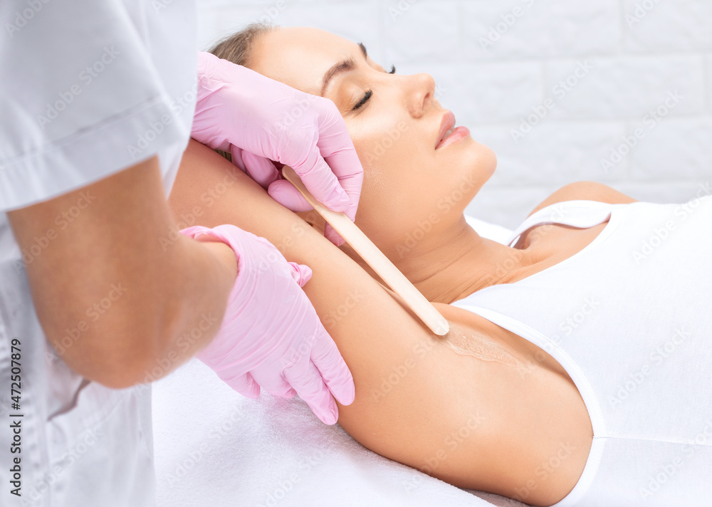 Elos epilation hair removal procedure on a woman’s body. Beautician doing laser rejuvenation in a beauty salon. Removing unwanted body hair. Hardware ipl cosmetology Elos epilation hair removal procedure on a woman’s body. Beautician doing laser rejuvenation in a beauty salon. Removing unwanted body hair. Hardware ipl cosmetology