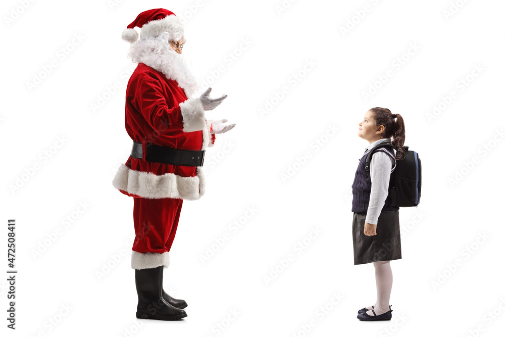 Santa claus talking to a schoolgirl with a backpack Santa claus talking to a schoolgirl with a backpack