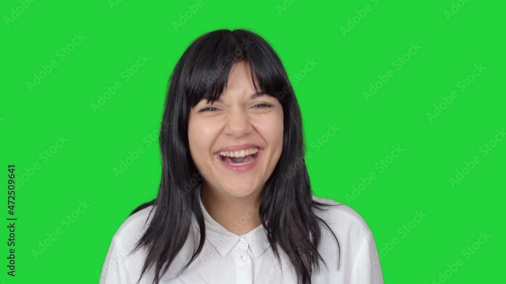 Woman being surprised and laughing. Surprised and smiling face expression of woman looking at camera. Green screen technique. Woman being surprised and laughing. Surprised and smiling face expression of woman looking at camera. Green screen technique.