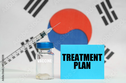 Vaccine, syringe and blue plate with the inscription - TREATMENT PLAN. In the background the flag of South Korea