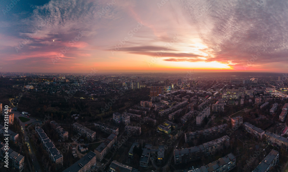 Aerial scenic vivid colorful sunset panorama view with epic skyscape. Kharkiv city center, Pavlove pole residential district streets and buildings in evening light