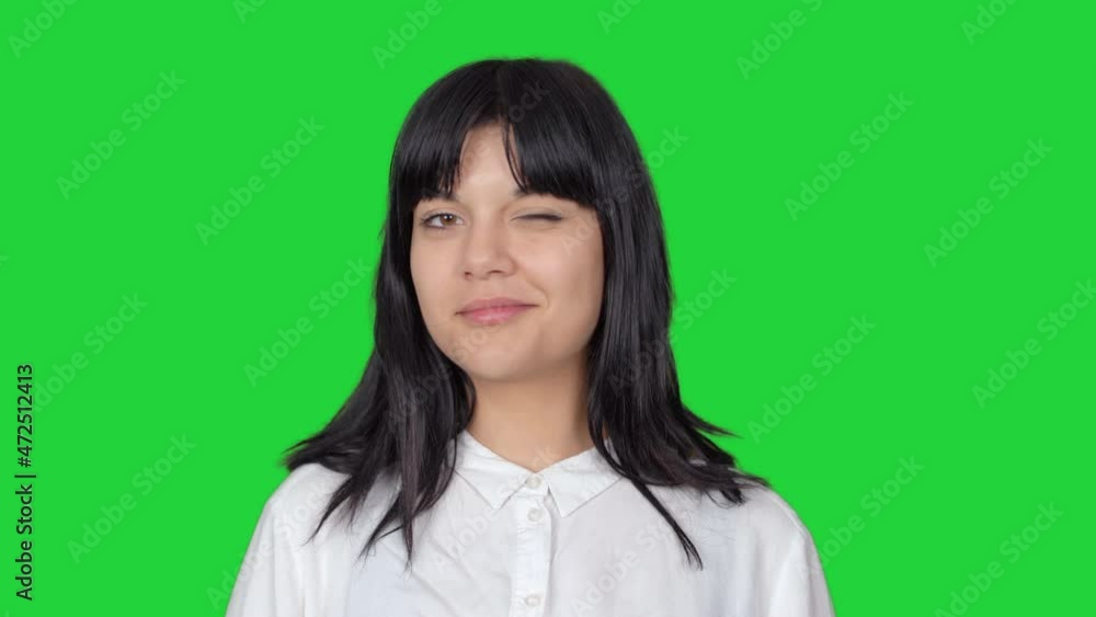 Woman wink. Woman looking at camera and winking. The background color is blue. Woman wink. Woman looking at camera and winking. The background color is blue.