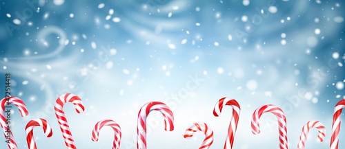 Christmas candy canes on snowy background.