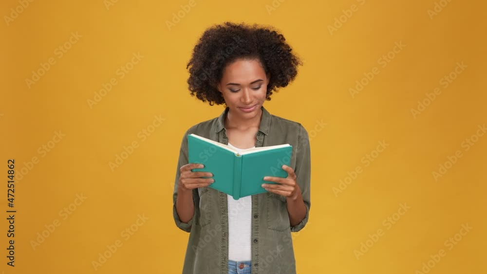 Excited lady read library paper book isolated mustard color background Excited lady read library paper book isolated mustard color background