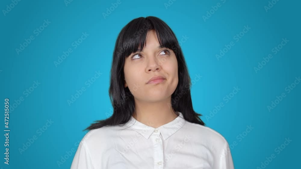 Thoughtful woman facial expression.
Woman thinks and comes up with an idea. The background color is blue.
Thoughtful woman facial expression.
Woman thinks and comes up with an idea. The background color is blue.