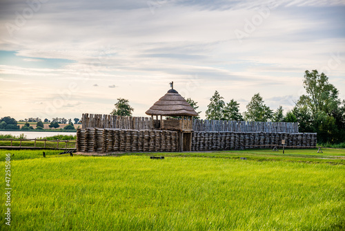 Biskupin, Poland - August 09, 2021. Archaeological site and a life-size model of a late Bronze Age fortified settlement in north-central Poland