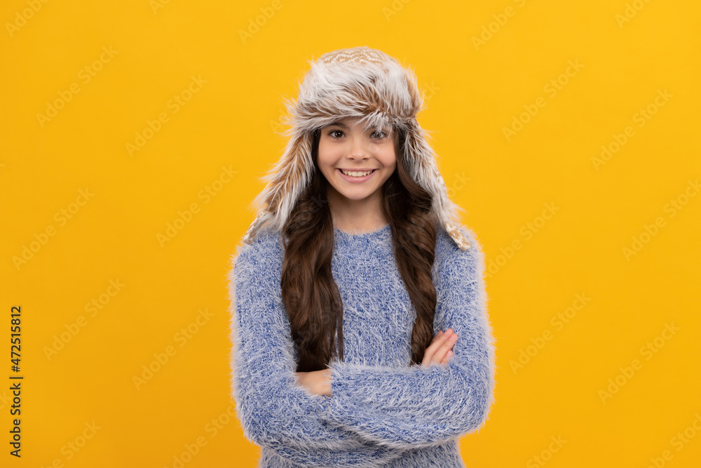 positive child in sweater and earflap hat on yellow background, season fashion positive child in sweater and earflap hat on yellow background, season fashion