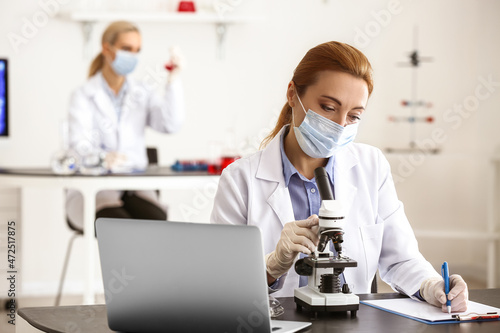 Scientist studying sample i...