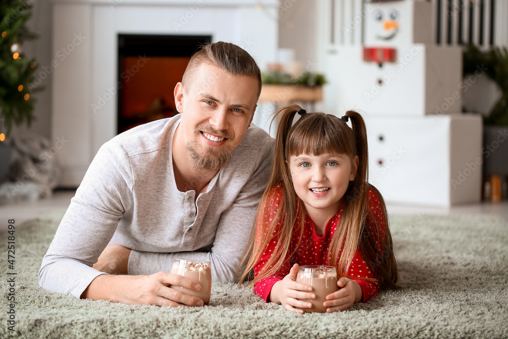 Happy daughter and father with cups of hot cocoa at home Happy daughter and father with cups of hot cocoa at home