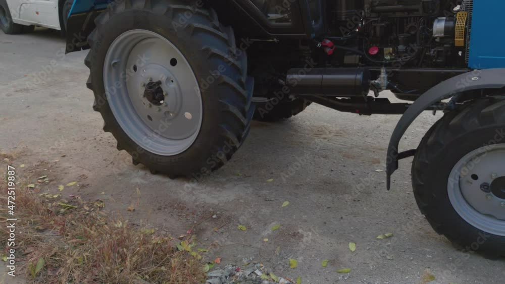 The tractor is driving reverse closeup of wheels The tractor is driving reverse closeup of wheels