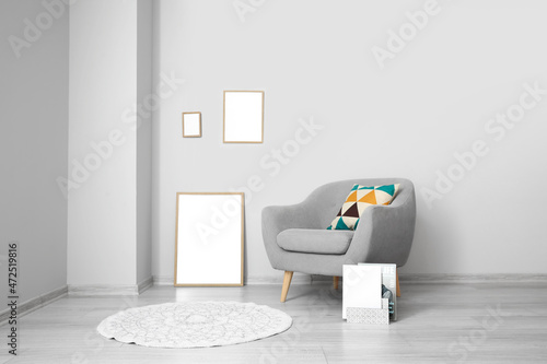 Blank frames and grey armch...