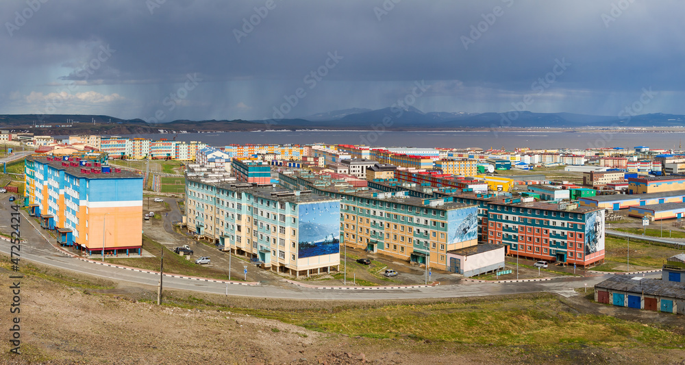 Beautiful summer panorama of the northern arctic city of Anadyr. Top view of the streets and colorful buildings. Billboards are visible on the buildings. Anadyr, Chukotka, Russia.