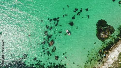 Aerial view of Baunty beach on cape Fiolent in Balaklava, Sevastopol. Crimea. Pleasure trip boats in azure sea water on sunny summer day. Travel and tourism concept footage photo