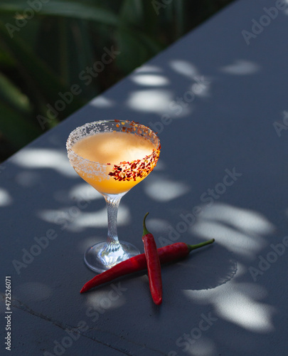 Chilli Margarita Cocktail outside on in bar restaurant garden with fresh chilli peppers. Great on it's own, for social media or for a poster.