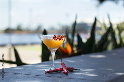 Chilli Margarita Cocktail outside on in bar restaurant garden with fresh chilly peppers. Great on it's own, for social media or for a poster.