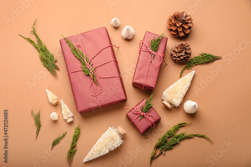 Composition with Christmas gifts, coniferous branches and decor on color background