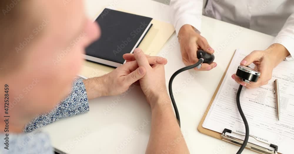 Doctor measuring blood pressure to patient in clinic 4k movie slow motion
