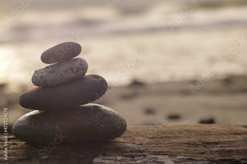 zen balancing stones on a wood with a coast background