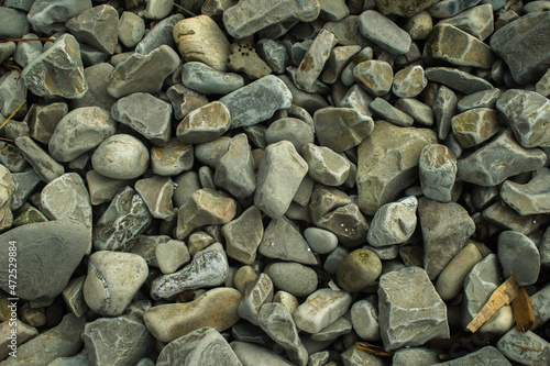 rocky beach by the sea, consisting of small and large multi-colored stones
