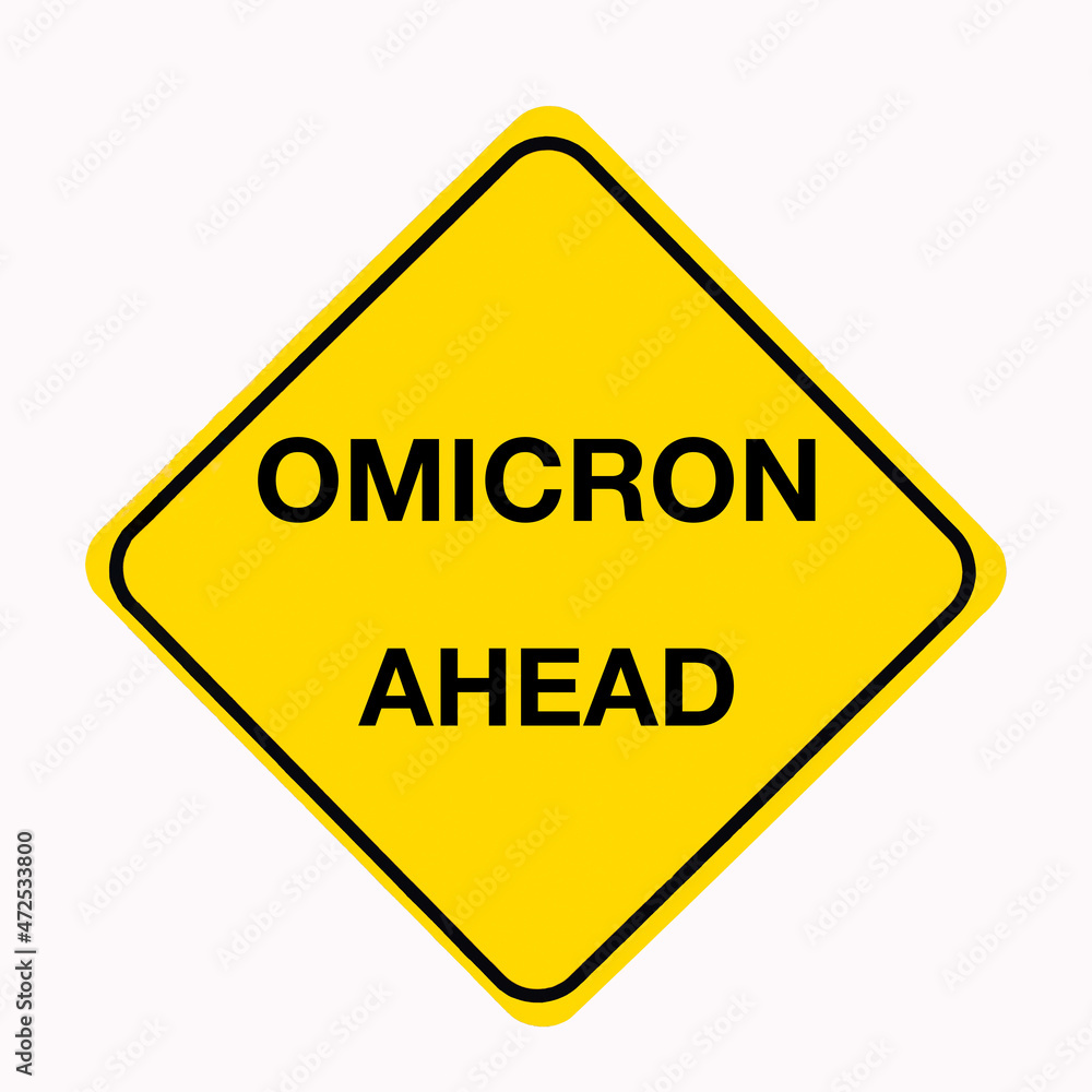 Bright yellow Road sign with the message OMICRON AHEAD as a coronavirus concept. Bright yellow Road sign with the message OMICRON AHEAD as a coronavirus concept.