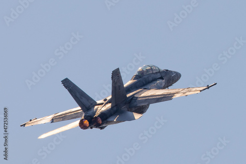 Tail view of a F-18 Hornet in beautiful light, , with afterburners on