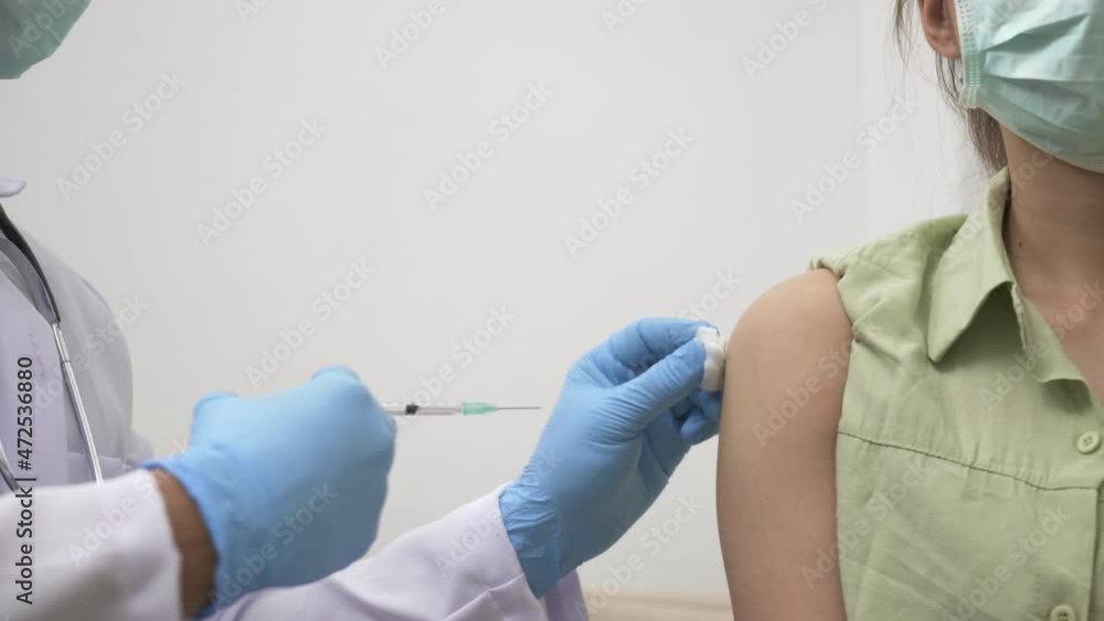 Vaccination, Doctor man injection coronavirus vaccine to young woman her shoulder, female patient in medical face mask, Covid-19 pandemic outbreak Medicine And Health Care Concept Vaccination, Doctor man injection coronavirus vaccine to young woman her shoulder, female patient in medical face mask, Covid-19 pandemic outbreak Medicine And Health Care Concept