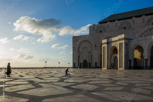 A mother and her children enjoying a peaceful and sunny afternoon at the Hassan II Mosque in Casablanca; the largest mosque in Africa, and the 3rd largest in the world