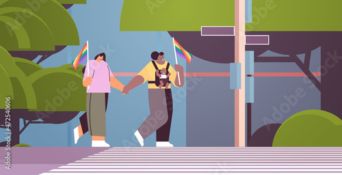 mix race female parents walking with little child lesbian family transgender love LGBT community concept