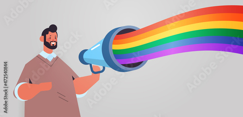 man announcing in loudspeaker with lgbt rainbow flag gay lesbian love parade pride festival transgender love concept