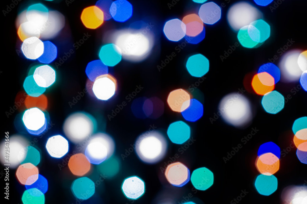 Fototapeta premium black abstract background with multicolored lights with bokeh in blur