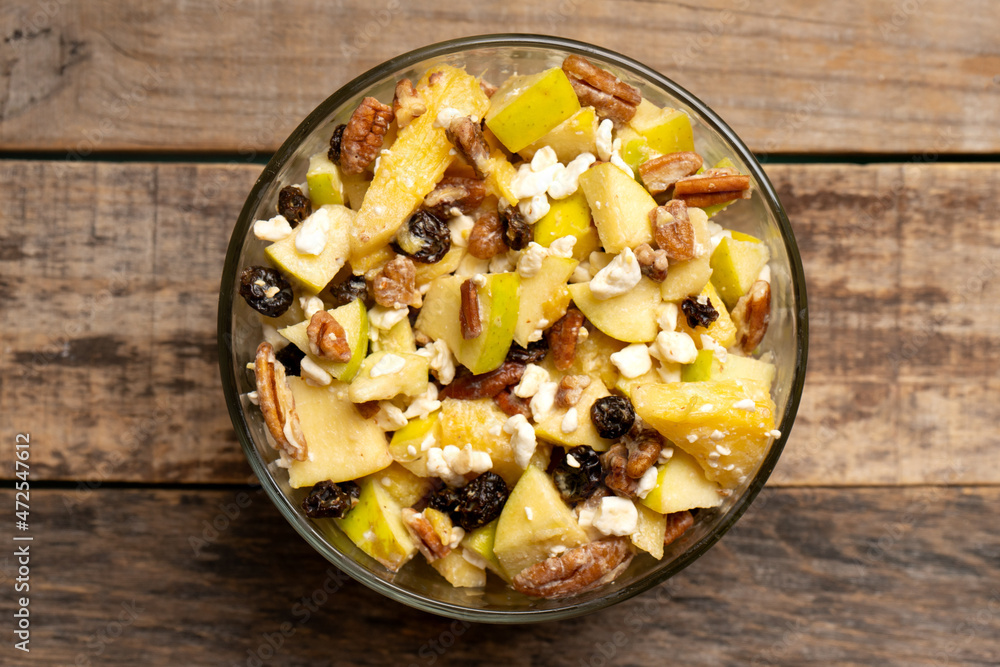 Apple salad with walnuts for Christmas on a wooden background Apple salad with walnuts for Christmas on a wooden background