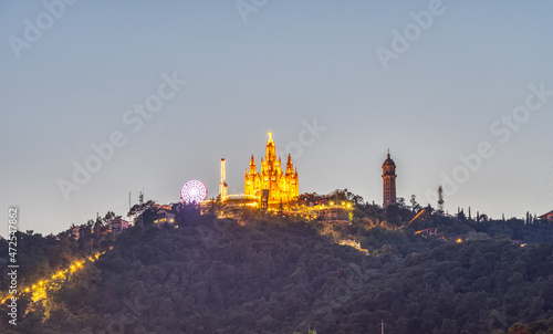 Mount Tibidabo in Barcelona with the church and the amusement park at night photo