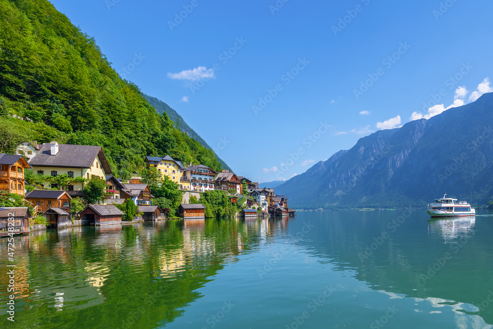 Hallstatt, Austria - A scenic picture postcard view of the famous village of Hallstatt reflecting in Hallstattersee lake in the Austrian Alps.
