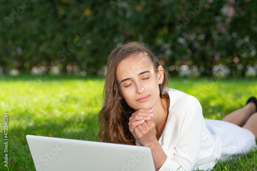 young woman and laptop in the park