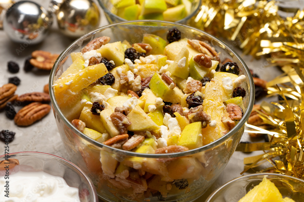 Apple salad with walnuts for Christmas on a gray background Apple salad with walnuts for Christmas on a gray background