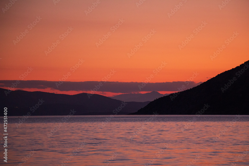 red sunset over the sea and mountains