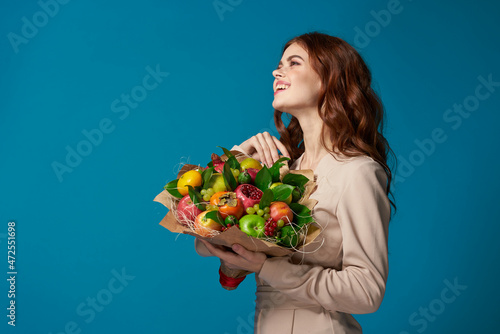 attractive woman beige coat fruit bouquet in hands Studio Model