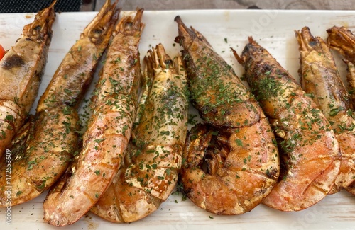 Delicious fried shrims, Grilled giant river prawn on a white plate, Barbecue seafood party, Traditional food recipe.