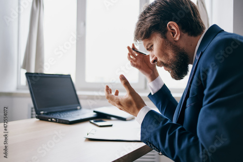 businessmen sitting at a desk in front of a laptop finance network professional